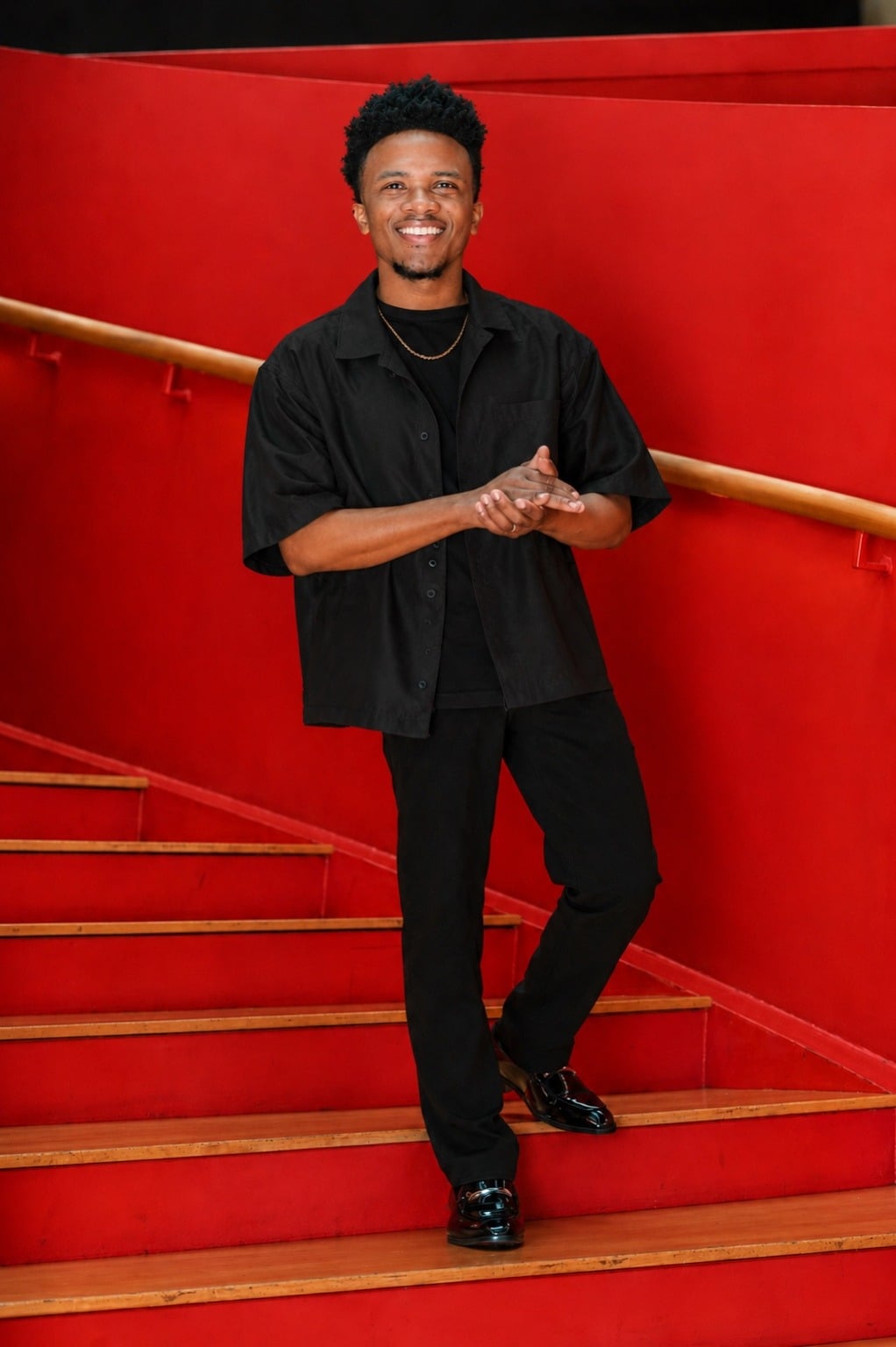 Prophet Jawaski Gardner smiling on a red staircase